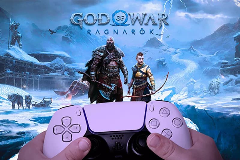 a person holding a video game controller in front of a video game